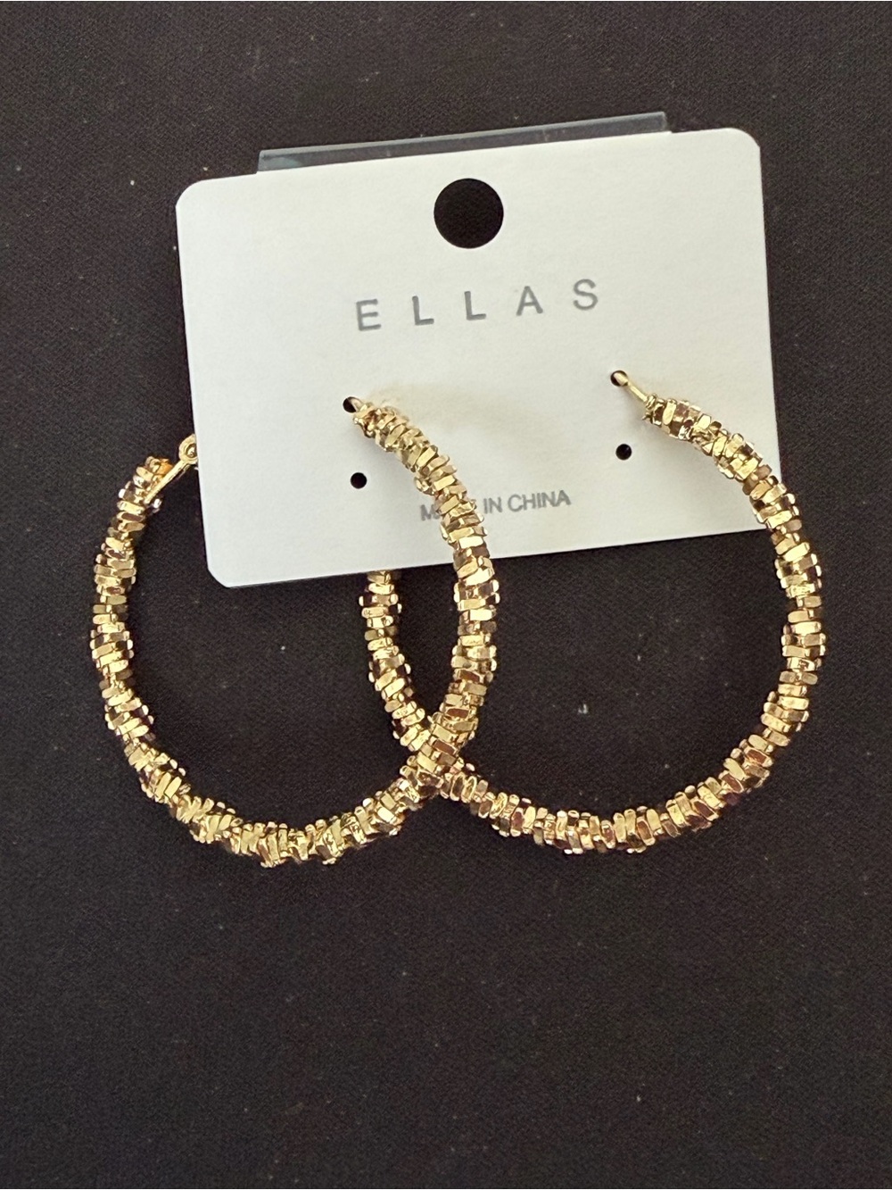 Ella’s gold tone twist hoop earrings
